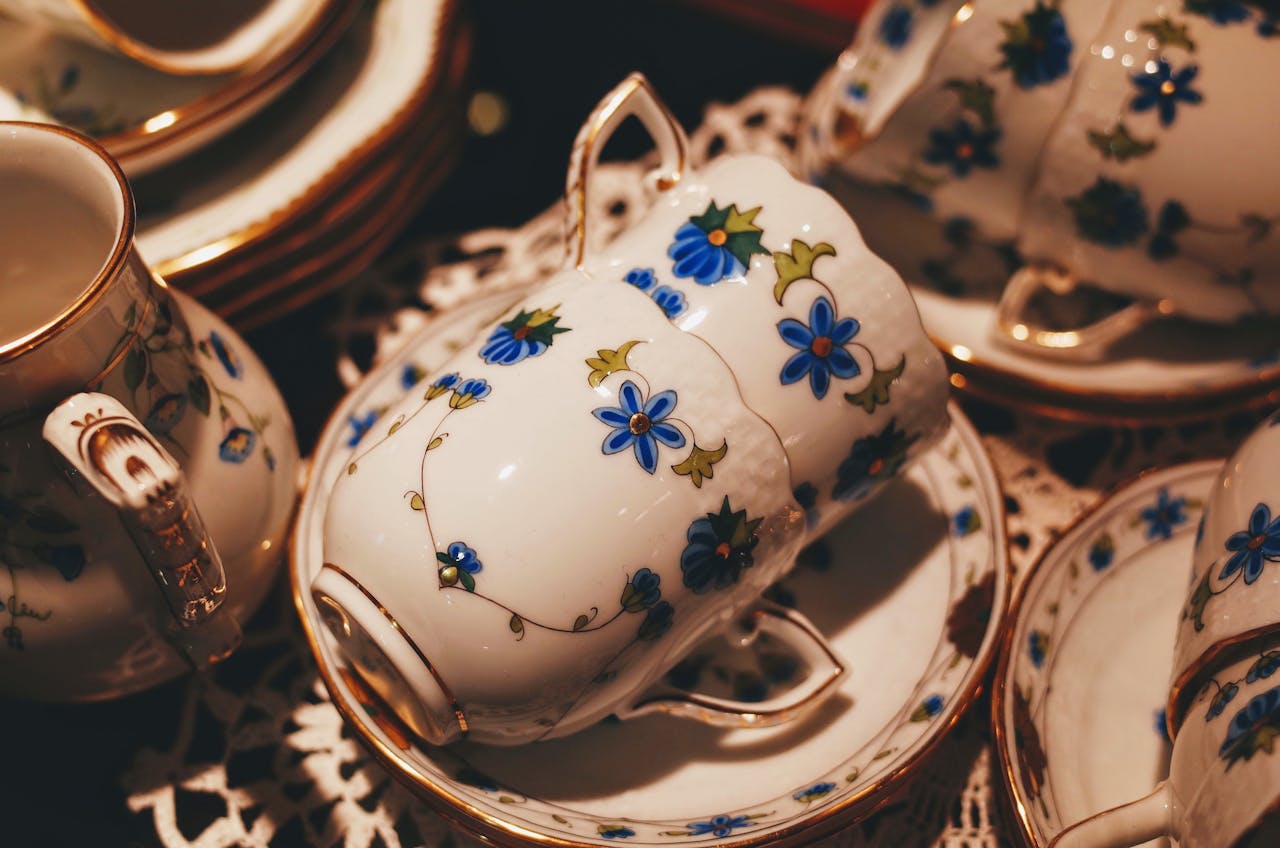 A beautifully detailed floral porcelain tea set with gold trim, perfect for elegant gatherings.